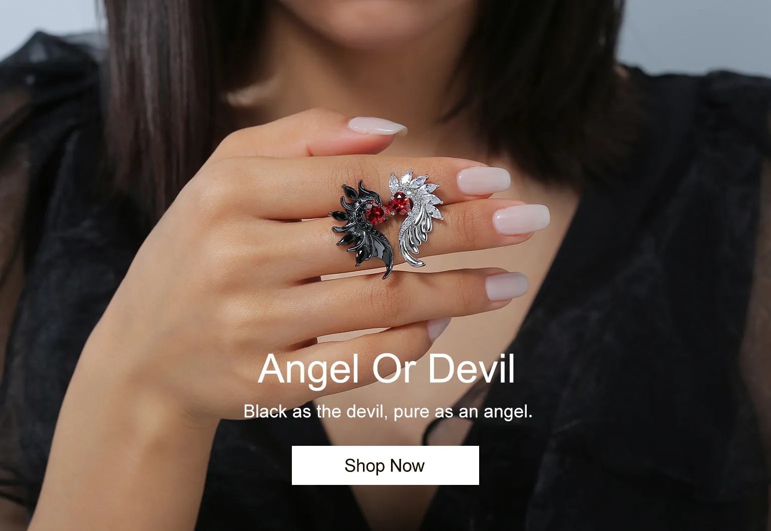 Model shows a pair of angel and devil wing earrings