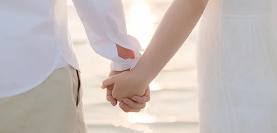 Couple Holding Hands in the Seaside