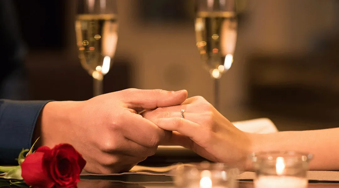 Couple Holding Hands in Dinner